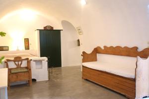 a bedroom with a wooden bed and a green door at Axion Studios in Aroniadika