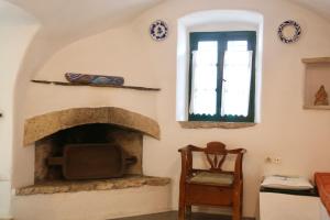a living room with a fireplace and a tv at Axion Studios in Aroniadika