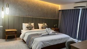 una camera d'albergo con un letto e un asciugamano sopra di Remember Hotel a Ban Khouaphan
