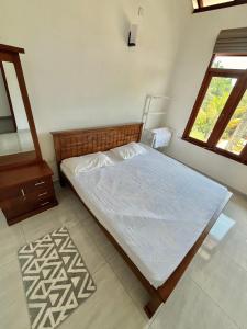 a bedroom with a bed and a window at THE DOCTORS VILLA in Ragama