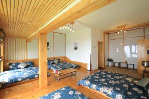 a bedroom with two beds and a wooden ceiling at Acasa Panorama Homestay in Vĩnh Phúc