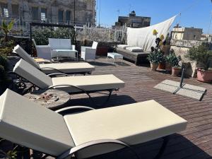 a group of tables and chairs on a roof at Azzurretta Guest House in Lecce
