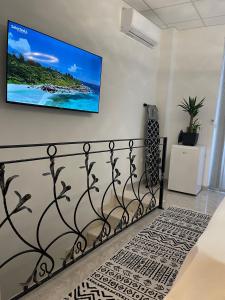 a living room with a tv on a wall at TLux in Stolac