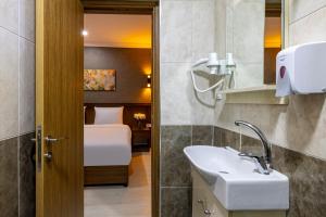 a bathroom with a sink and a bed in a room at Diamond Beyazit Hotel in Istanbul