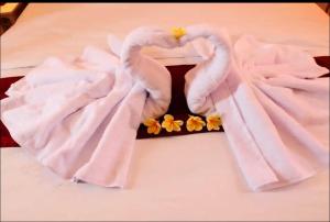 a pair of swans made out of towels on a bed at Belvilla 93800 The Abhinaya Villa Near Central Ubud in Payangan