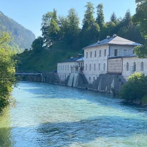 a river with buildings on the side of it at Ferienwohnung Kohl - Dachlmoos in Bischofswiesen