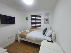 a white bedroom with a bed and a window at 1. Single Room (Professional, Trades) Welcome in Luton