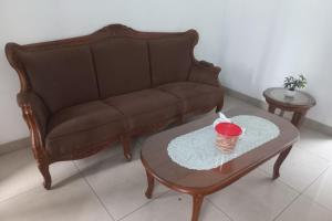 a living room with a couch and a coffee table at Hotel O Salma Homestay Syariah Near alun alun kota purwokerto in Purwokerto