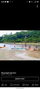 a group of people on a boat in the water at Nongangellakefarm in Taytay