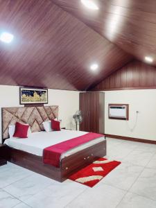 a bedroom with a large bed with a red blanket at Shiva Green Valley Farms in Bikaner +11 photos
