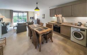 a kitchen with a table and a dining room at Stunning Home In Saint-Laurent-De-La-Ca in Saint-Laurent-de-la-Cabrerisse