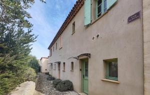 a building with a green door on the side of it at Stunning Home In Saint-Laurent-De-La-Ca in Saint-Laurent-de-la-Cabrerisse