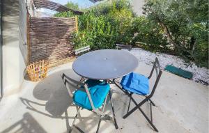 a table and two chairs sitting at a table at Stunning Home In Saint-Laurent-De-La-Ca in Saint-Laurent-de-la-Cabrerisse +17 photos