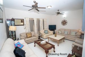 a living room with couches and a tv at Swarloke Apartment at Gulshan 2,Dhaka in Dhaka