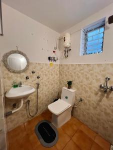 a bathroom with a toilet and a sink at Bayou Homestay and backwaters in Goa