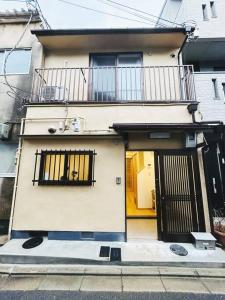 a building with a balcony on the side of it at Meet Inari in Kyoto