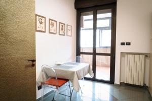 stół i krzesła w pokoju z oknem w obiekcie Casa Garruba Central Station w mieście Bari