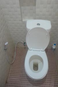 uma casa de banho com um WC branco numa cabina em SPOT ON 93852 Fermansio Homestay 2 em Medan