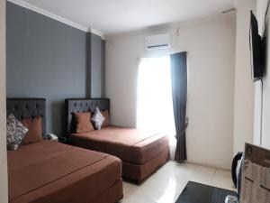 Postel nebo postele na pokoji v ubytování Pasifik Hotel Jakarta