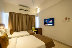 Ein Bett oder Betten in einem Zimmer der Unterkunft Freesia Residency By Express Inn - Navi Mumbai