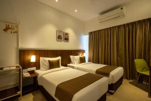 Ein Bett oder Betten in einem Zimmer der Unterkunft Freesia Residency By Express Inn - Navi Mumbai