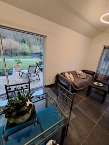 a living room with a large window and a couch at Chez Eve&Bruno 