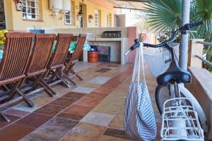 a patio with chairs and a bike parked on a porch at El Gachero in Puerto de Mazarrón
