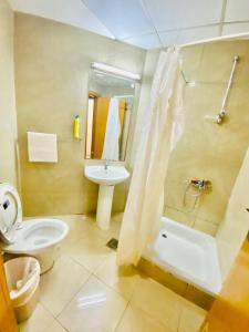 a bathroom with a toilet and a sink and a shower at MC Budget Rooms for Girls Apartment Number 4202 in Dubai