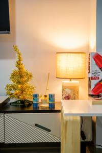 a christmas tree on a desk with a lamp at BGC 2BR Uptown Parksuites with balcony and bathtub in Manila