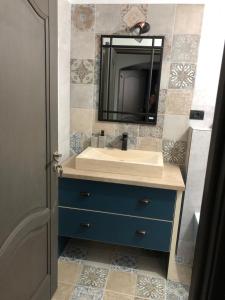 a bathroom with a blue sink and a mirror at La Foisor in Vărbilău