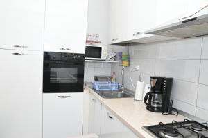 Kuchyň nebo kuchyňský kout v ubytování Apartment Oscar
