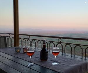 a table with two glasses and a bottle of wine at Effrosyni's House in Kanália