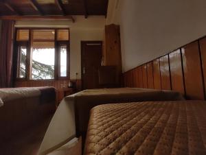 Postel nebo postele na pokoji v ubytování TSUKIMI Homestay, Naggar, Manali