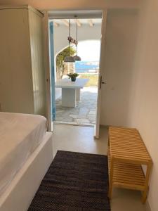 a bedroom with a bed and a view of the ocean at Mykonian 4 Bd Ocean Dream House in Agios Sostis in Agios Sostis Mykonos