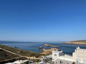 a view of the ocean and a white building at Mykonian 4 Bd Ocean Dream House in Agios Sostis in Agios Sostis Mykonos