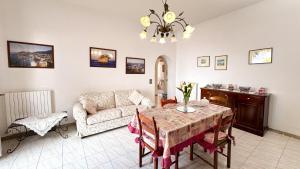 a living room with a table and a couch at Villa La Magnolia in Ischia