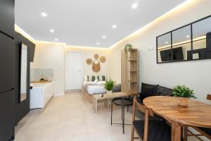 a living room with a dining room table and a bedroom at EXCLUSIVE APARTMENT JACUZZi in Málaga +13 photos