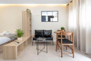 a living room with a bed and a table and chairs at EXCLUSIVE APARTMENT JACUZZi in Málaga