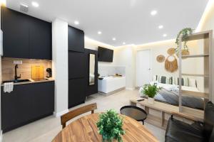 a kitchen and a living room with a dining room table at EXCLUSIVE APARTMENT JACUZZi in Málaga