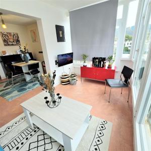 a living room with a white table and a piano at Els Terrers Sun Flat in Benicàssim