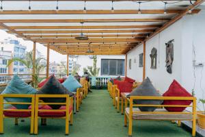 a row of chairs with colorful pillows on a patio at Bardali Restro and Residency in Kathmandu