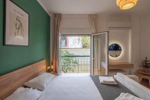 a bedroom with a large bed with a green wall at Iris luxury apartment in Athens