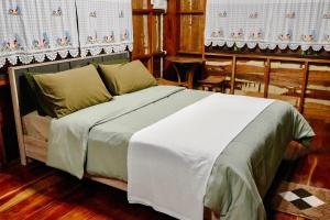 a bedroom with a large bed with white sheets at Pang Long Chao resort in Trang