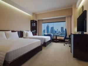 Posteľ alebo postele v izbe v ubytovaní Manhattan Hotel Jakarta