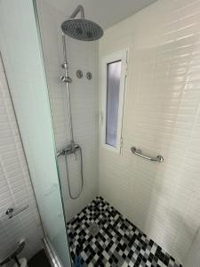 a shower with a glass door in a bathroom at ALOJAMIENTO SARDOY in Murcia