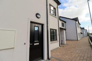 a white building with a black door on a street at Inviting 2-Bed Apartment in Dublin in Dublin
