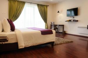 ein Schlafzimmer mit einem Bett und einem großen Fenster in der Unterkunft Windermere Hotel in Shillong