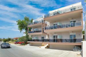 a building with a car parked in front of it at AR APARTMENTS in Nikiti