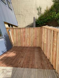 a wooden fence next to a wooden deck at Le Grab in Saint-Jacques-des-Blats