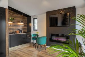 a kitchen with a table and chairs and a fireplace at Green Resort Bran in Bran